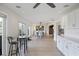 Open concept dining room and kitchen area featuring stainless appliances and light wood floors at 3956 Versailles Dr, Tampa, FL 33634