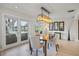 Dining area with patio access featuring modern light fixture, mirrors, and water view at 3956 Versailles Dr, Tampa, FL 33634