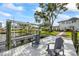 Waterfront dock featuring a boat lift and lounge chairs to relax, surrounded by lush greenery and a tranquil atmosphere at 3956 Versailles Dr, Tampa, FL 33634