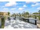 Waterfront dock featuring lounge chairs for relaxing and a boat lift, with beautiful views of neighboring homes at 3956 Versailles Dr, Tampa, FL 33634