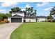 Contemporary home with a two-car garage, well-kept lawn, and modern design elements, a perfect blend of style at 3956 Versailles Dr, Tampa, FL 33634