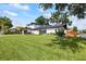 Stunning two-story home with modern architecture, manicured lawn, and sleek black garage door at 3956 Versailles Dr, Tampa, FL 33634