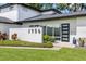 Close up of modern home's front entrance featuring a stylish door, manicured landscaping, and clear house numbers at 3956 Versailles Dr, Tampa, FL 33634