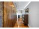 Long hallway with wood floors, wood closet, grey walls, and black shelves at 3956 Versailles Dr, Tampa, FL 33634