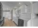 Kitchen featuring stainless steel appliances, white cabinets, and quartz countertops at 3956 Versailles Dr, Tampa, FL 33634