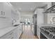 Updated kitchen with white cabinets, stainless steel appliances, and a view to the backyard at 3956 Versailles Dr, Tampa, FL 33634