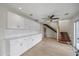Open concept dining room and living area featuring an open staircase and white cabinets at 3956 Versailles Dr, Tampa, FL 33634