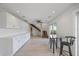 Open concept dining room and living area featuring an open staircase and white cabinets at 3956 Versailles Dr, Tampa, FL 33634