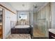 Modern main bathroom featuring a soaking tub and a separate glass enclosed shower at 3956 Versailles Dr, Tampa, FL 33634