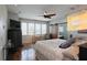 Bright main bedroom featuring hardwood floors, recessed lighting, ceiling fan, and a desk at 3956 Versailles Dr, Tampa, FL 33634