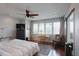Bright main bedroom featuring hardwood floors, recessed lighting, ceiling fan, and a waterfront view at 3956 Versailles Dr, Tampa, FL 33634
