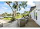 Charming backyard patio featuring outdoor furniture, lush greenery, and a waterfront view, perfect for relaxation at 3956 Versailles Dr, Tampa, FL 33634
