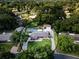 An aerial view of a private home showcasing the property's pool and garage space nestled among lush greenery at 4205 Helene Pl, Valrico, FL 33594