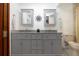Bathroom featuring double sink vanity with granite countertop, cabinetry, and framed mirrors at 4205 Helene Pl, Valrico, FL 33594
