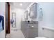 Bright bathroom featuring double sink vanity with grey cabinets and granite countertop, accompanied by an adjacent toilet at 4205 Helene Pl, Valrico, FL 33594