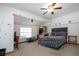 Bright bedroom with ceiling fan, carpet floor, bed, decoratived walls, and natural light at 4205 Helene Pl, Valrico, FL 33594