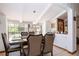 Comfortable dining area featuring a dark wood table, seating for six, and natural lighting at 4205 Helene Pl, Valrico, FL 33594