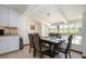 Dining area with natural light, sleek table setting, and direct access to the kitchen at 4205 Helene Pl, Valrico, FL 33594