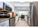 Efficient kitchen design with stainless appliances, granite countertops, and white cabinetry at 4205 Helene Pl, Valrico, FL 33594