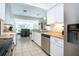 Bright kitchen boasts granite countertops, stainless steel appliances, and white cabinetry with an eat-in dining area at 4205 Helene Pl, Valrico, FL 33594