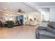 Open-concept living room featuring neutral tile floors, a ceiling fan, and access to the kitchen at 4205 Helene Pl, Valrico, FL 33594