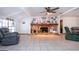Bright living area featuring a stone fireplace, tile floors, and comfortable seating at 4205 Helene Pl, Valrico, FL 33594