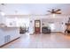 Open floor plan with neutral tile, ceiling fan, and seamless flow into the dining area at 4205 Helene Pl, Valrico, FL 33594