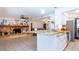 Open-concept view from the kitchen into the living room which features a stone fireplace and tiled floors at 4205 Helene Pl, Valrico, FL 33594