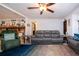 Open-concept living area with a stone fireplace, tile flooring, and comfortable gray seating at 4205 Helene Pl, Valrico, FL 33594