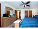 Spacious main bedroom with carpet, ceiling fan, dresser, and access to en-suite bathroom at 4205 Helene Pl, Valrico, FL 33594