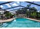 Inviting screened-in pool area featuring ample lounging space and lush landscaping at 4205 Helene Pl, Valrico, FL 33594