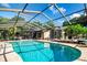 Sparkling private pool under screened enclosure, surrounded by patio furniture and lush landscaping at 4205 Helene Pl, Valrico, FL 33594