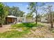 Large backyard featuring a covered patio, shed, and lush landscaping at 4417 W El Prado Blvd, Tampa, FL 33629