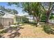 Exterior view of home with mature trees, manicured lawn, and charming architectural details at 4417 W El Prado Blvd, Tampa, FL 33629