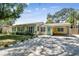 Attractive single-Gathering home with a light yellow exterior, a carport, and a manicured front lawn at 4417 W El Prado Blvd, Tampa, FL 33629