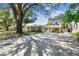 Inviting home featuring a spacious driveway leading to a well-maintained exterior with mature trees at 4417 W El Prado Blvd, Tampa, FL 33629