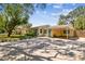 Beautiful single-story home with a well-manicured lawn, covered parking, and a charming yellow exterior at 4417 W El Prado Blvd, Tampa, FL 33629