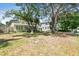 Lovely home featuring a well-maintained lawn, mature trees, and a light-colored exterior at 4417 W El Prado Blvd, Tampa, FL 33629