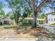 Charming home featuring mature trees, lawn, and a driveway at 4417 W El Prado Blvd, Tampa, FL 33629
