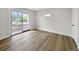 Bright bedroom with wood-look flooring, white walls, and sliding glass doors leading to the backyard at 451 Avenida De Mayo, Sarasota, FL 34242