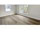 Bright bedroom with wood-look flooring, white walls, and large windows at 451 Avenida De Mayo, Sarasota, FL 34242