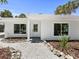 Well-maintained single-story home featuring a clean design and attractive landscaping at 451 Avenida De Mayo, Sarasota, FL 34242