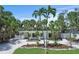 Charming single-story home features a well-manicured front yard with mature landscaping and a gravel driveway at 451 Avenida De Mayo, Sarasota, FL 34242