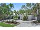 Charming single-story home features a well-manicured front yard with mature landscaping and a gravel driveway at 451 Avenida De Mayo, Sarasota, FL 34242