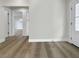 Hallway featuring freshly painted walls, wood-look flooring, new trim, and bright white doors at 451 Avenida De Mayo, Sarasota, FL 34242