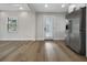 Spacious room showcasing hardwood floors, modern appliances, and a sunny exterior door at 451 Avenida De Mayo, Sarasota, FL 34242