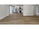 Open living space with hardwood floors leading into a kitchen area with stainless steel appliances at 451 Avenida De Mayo, Sarasota, FL 34242