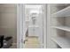 Bathroom view from the walk-in closet offers a single sink vanity and tiled floors at 5000 Culbreath Key Way # 1-112, Tampa, FL 33611