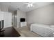Bedroom featuring a ceiling fan, dresser with TV, and a view to the ensuite bathroom at 5000 Culbreath Key Way # 1-112, Tampa, FL 33611