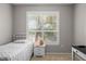 This cozy bedroom offers ample natural light, a twin bed, and a nightstand at 5000 Culbreath Key Way # 1-112, Tampa, FL 33611